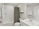Cozy bathroom featuring tub-shower, checkered shower curtain, and a white single sink vanity at 4918 Neuse Commons Ln, Raleigh, NC 27616