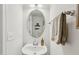 Bright half-bathroom with floating sink, and mirrored wall decor at 4918 Neuse Commons Ln, Raleigh, NC 27616