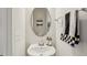 Bright half-bathroom with floating sink, and mirrored wall decor at 4918 Neuse Commons Ln, Raleigh, NC 27616