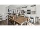 Open concept dining room with table, chairs, and stainless steel appliances at 4918 Neuse Commons Ln, Raleigh, NC 27616
