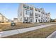 Charming two-story townhomes with manicured lawns, sidewalks, and traditional architectural details for attractive curb appeal at 4918 Neuse Commons Ln, Raleigh, NC 27616