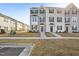 Charming two-story townhomes with manicured lawns, sidewalks, and traditional architectural details for attractive curb appeal at 4918 Neuse Commons Ln, Raleigh, NC 27616