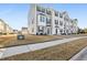 Charming two-story townhomes with manicured lawns, sidewalks, and traditional architectural details for attractive curb appeal at 4918 Neuse Commons Ln, Raleigh, NC 27616