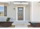 Close-up of a stylish gray front door with dark fixtures, house number, and landscaped entrance for a warm welcome at 4918 Neuse Commons Ln, Raleigh, NC 27616