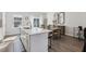 Eat-in kitchen features a quartz island and dining space with large windows at 4918 Neuse Commons Ln, Raleigh, NC 27616