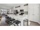 Bright eat-in kitchen features stainless steel appliances, white cabinetry, and large center island with seating at 4918 Neuse Commons Ln, Raleigh, NC 27616