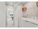 Functional laundry room with modern appliances, wire shelving, and easy access to the bedroom at 4918 Neuse Commons Ln, Raleigh, NC 27616