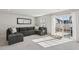 Bright living room with gray sectional and walkout access to patio at 4918 Neuse Commons Ln, Raleigh, NC 27616