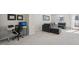 Cozy living room with grey sofa, ottoman, and modern workspace at 4918 Neuse Commons Ln, Raleigh, NC 27616