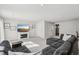 Spacious living room features gray sectional, fireplace, and open floor plan at 4918 Neuse Commons Ln, Raleigh, NC 27616