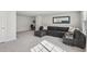Open-concept living room with gray sofa and bonus desk space at 4918 Neuse Commons Ln, Raleigh, NC 27616