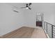 Bedroom with wall unit, ceiling fan, light wood floors, and bathroom access at 615 W Peace St # 406, Raleigh, NC 27605