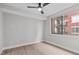 Minimalist bedroom with hardwood flooring, and a large window offering views of the outdoors at 615 W Peace St # 406, Raleigh, NC 27605