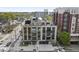 Modern condo building with brick and black accents, featuring balconies and garage doors at 615 W Peace St # 406, Raleigh, NC 27605