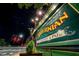 Outdoor view of a restaurant and pub at night, showcasing vibrant signage and street scene at 615 W Peace St # 406, Raleigh, NC 27605