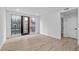 Neutral living area with hardwood floors, white walls, and a view to the building's exterior at 615 W Peace St # 406, Raleigh, NC 27605