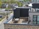 Rooftop deck with a wooden floor, outdoor seating, and city views at 615 W Peace St # 406, Raleigh, NC 27605