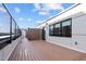Spacious rooftop deck with wood-look flooring, offering an outdoor living area at 615 W Peace St # 406, Raleigh, NC 27605