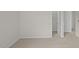 Cozy bedroom with neutral carpet adjacent to a closet and white doors at 6453 Alfalfa Ln, Wake Forest, NC 27587