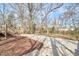Exterior of home featuring a concrete driveway leading to a natural backyard space at 723 Holloway St, Durham, NC 27701