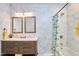 Elegant bathroom featuring marble tile, double vanity, and a bathtub with shower at 723 Holloway St, Durham, NC 27701