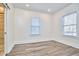 Bright empty bedroom featuring two windows and wood-look floors at 723 Holloway St, Durham, NC 27701