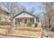 Quaint home with tidy yard, stone retaining walls, a welcoming front porch and driveway access at 723 Holloway St, Durham, NC 27701