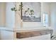 Close-up of a decorative fireplace featuring a rustic wood beam mantel and stylish artwork, adding charm to the room at 723 Holloway St, Durham, NC 27701