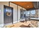 Cozy front porch with a wooden ceiling, stone pillars, and chairs for relaxation at 723 Holloway St, Durham, NC 27701