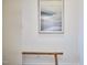 Welcoming hallway with a wooden bench and mountainscape painting hung above at 723 Holloway St, Durham, NC 27701
