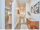 Bright hallway with hardwood floors, leading to a kitchen and entryway at 723 Holloway St, Durham, NC 27701