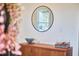 Hallway with modern wooden console table and a round mirror, creating a stylish and functional space at 723 Holloway St, Durham, NC 27701