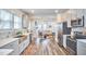 Open kitchen and living room concept featuring gray cabinets and stainless steel appliances at 723 Holloway St, Durham, NC 27701