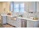 Kitchen with stainless steel sink, white countertops, and gray cabinets at 723 Holloway St, Durham, NC 27701