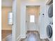 Laundry area with modern washer and dryer, and view to a bright outdoor entry at 723 Holloway St, Durham, NC 27701