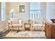 Cozy sitting area with comfortable chairs, accent table, stylish rug, and natural light creating a relaxing atmosphere at 723 Holloway St, Durham, NC 27701