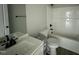 Bathroom with a bathtub, toilet, single sink and mirror, all in matching white at 73 Grace Pond Ave, Benson, NC 27504