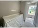 Bathroom featuring a covered double vanity with natural light streaming through a window at 73 Grace Pond Ave, Benson, NC 27504