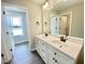 Bathroom with a double sink vanity, stylish fixtures, and a view to the window at 73 Grace Pond Ave, Benson, NC 27504