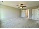 Bright bedroom with a ceiling fan and a modern barn door leading to the bathroom at 73 Grace Pond Ave, Benson, NC 27504
