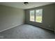 Comfortable bedroom with plush carpeting and two windows offering bright natural light at 73 Grace Pond Ave, Benson, NC 27504