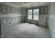 Unfinished bedroom with natural light through a pair of windows at 73 Grace Pond Ave, Benson, NC 27504