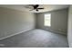 Comfortable bedroom with neutral carpet, ceiling fan, and a bright window at 73 Grace Pond Ave, Benson, NC 27504