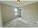 Neutral bedroom with plush carpeting, natural light, and closet at 73 Grace Pond Ave, Benson, NC 27504