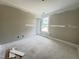 Bedroom offers natural light from a window, neutral walls, and a connecting door at 73 Grace Pond Ave, Benson, NC 27504