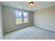 Bedroom with large windows and plush carpet at 73 Grace Pond Ave, Benson, NC 27504