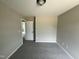 Bedroom with soft carpeting and neutral walls, featuring a doorway to another room at 73 Grace Pond Ave, Benson, NC 27504