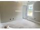 Bedroom offers natural light from a window, neutral walls, and a connecting door at 73 Grace Pond Ave, Benson, NC 27504