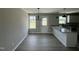 Bright dining area featuring modern chandelier, large windows and a door to the backyard at 73 Grace Pond Ave, Benson, NC 27504