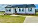 An inviting single-story home featuring gray shutters, brick accents, and a well-manicured front yard at 73 Grace Pond Ave, Benson, NC 27504
